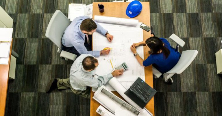 Project Management Gears - Three People Sitting Beside Table