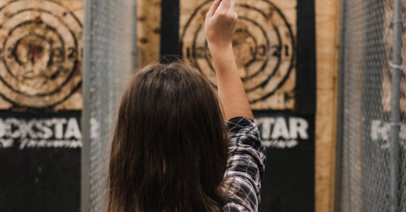 Rocket Target - Woman in Black and White Stripe Shirt Raising Her Hands