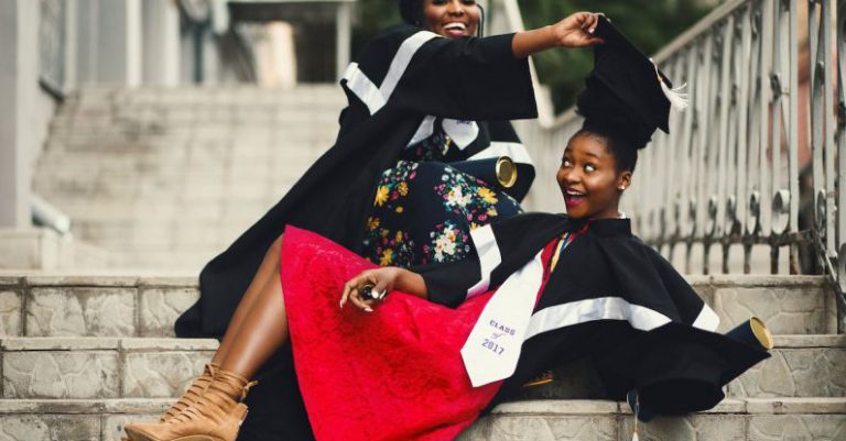 Stairs Success - Shallow Focus Photography of Two Women in Academic Dress on Flight of Stairs