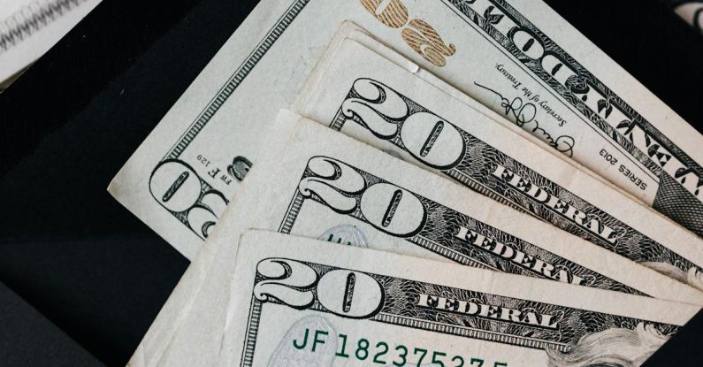 Plan Growth - Stack of dollars and black envelope with banknotes inside