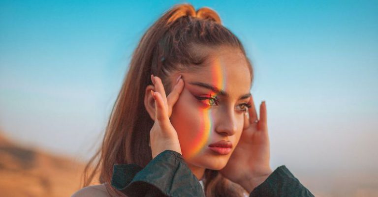 Brain Rainbow - Woman in Green Jacket Covering Her Face With Her Hand