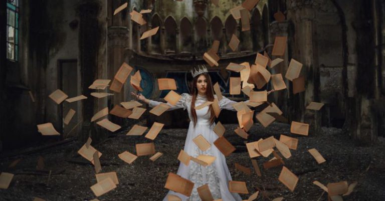 Book Crown - Woman in a Costume and a Crown with Old Yellow Book Pages Flying Around Her