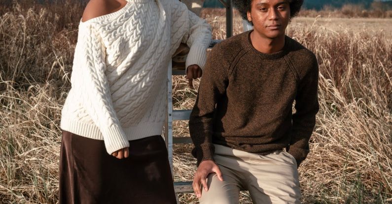 Mountain Ladder - A Woman in White Sweater Standing Near the Man Sitting on the Ladder