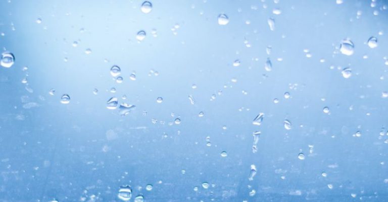 Focus Bubble - Close-up of Water Droplets Against Blue Background