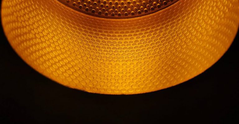 Brainstorm Bulb - A close up of a light fixture with a yellow light