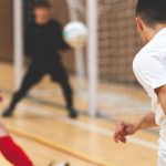 Team Puzzle - A man in a red shirt is kicking a soccer ball