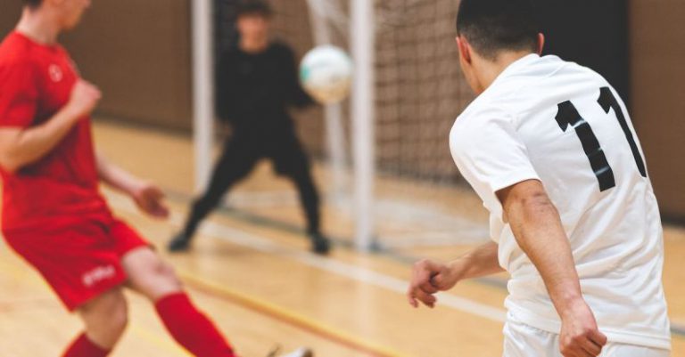 Team Puzzle - A man in a red shirt is kicking a soccer ball