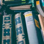 Finance Book - Stack of Brown and Red Printed Hardbound Books