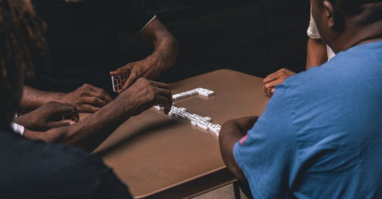 Habits Domino - Four People Playing Domino