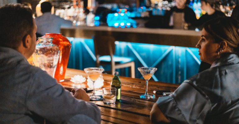 Meeting Efficiency - Two people sitting at a bar with drinks