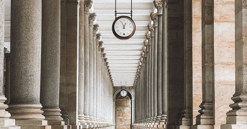 Clock Sprout - A long hallway with columns and a clock