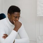 Clock Strategies - Man in White Sweater Playing Chess