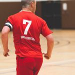 Keys Team - A man in red soccer uniform running with the ball